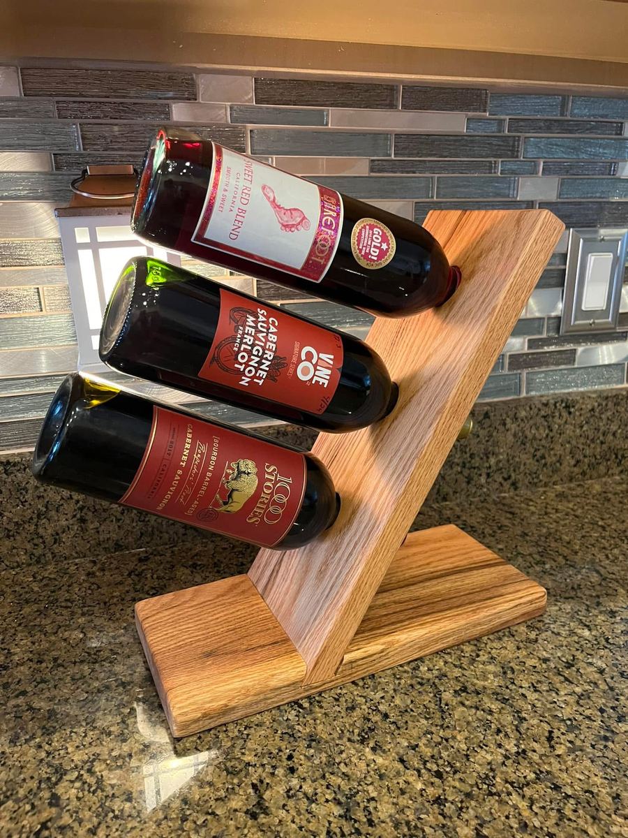 Wine rack holding three bottles at an angle